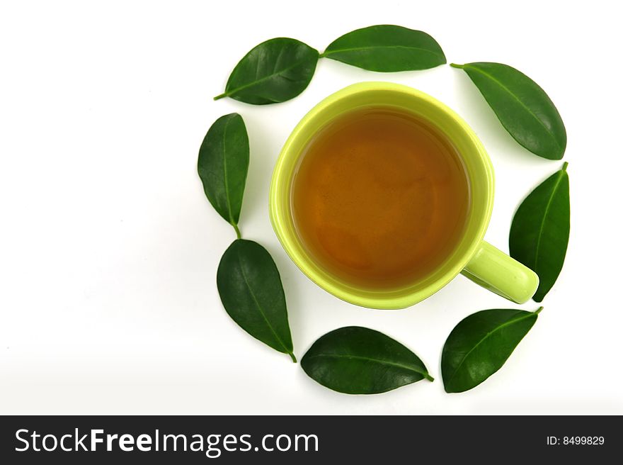 Cup of green tea rounded by leafs. Cup of green tea rounded by leafs