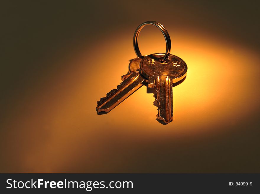 Close up of two keys on golden spot light