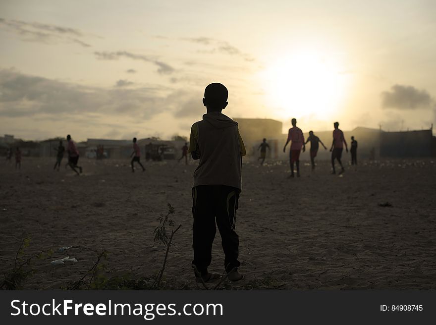 A young child looks on as older boys play football next to an IDP camp in Mogadishu, Somalia, on August 19. Illegal under al Shabab, football has made a huge comeback in Somalia, with Mogadishu&#x27;s streets literally filling up with children each afternoon as they come out to play the game. AU UN IST PHOTO / TOBIN JONES. A young child looks on as older boys play football next to an IDP camp in Mogadishu, Somalia, on August 19. Illegal under al Shabab, football has made a huge comeback in Somalia, with Mogadishu&#x27;s streets literally filling up with children each afternoon as they come out to play the game. AU UN IST PHOTO / TOBIN JONES.