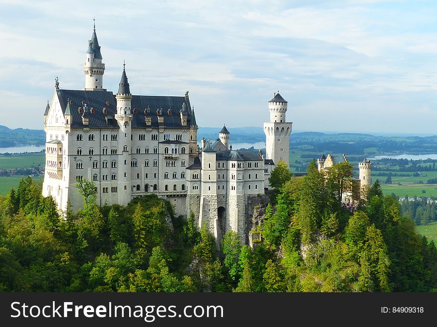 A view of an ancient castle surrounded by a forest. A view of an ancient castle surrounded by a forest.