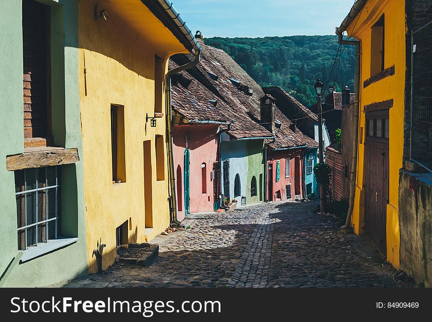 A row of humble colorful houses along a cobbled alley. A row of humble colorful houses along a cobbled alley.