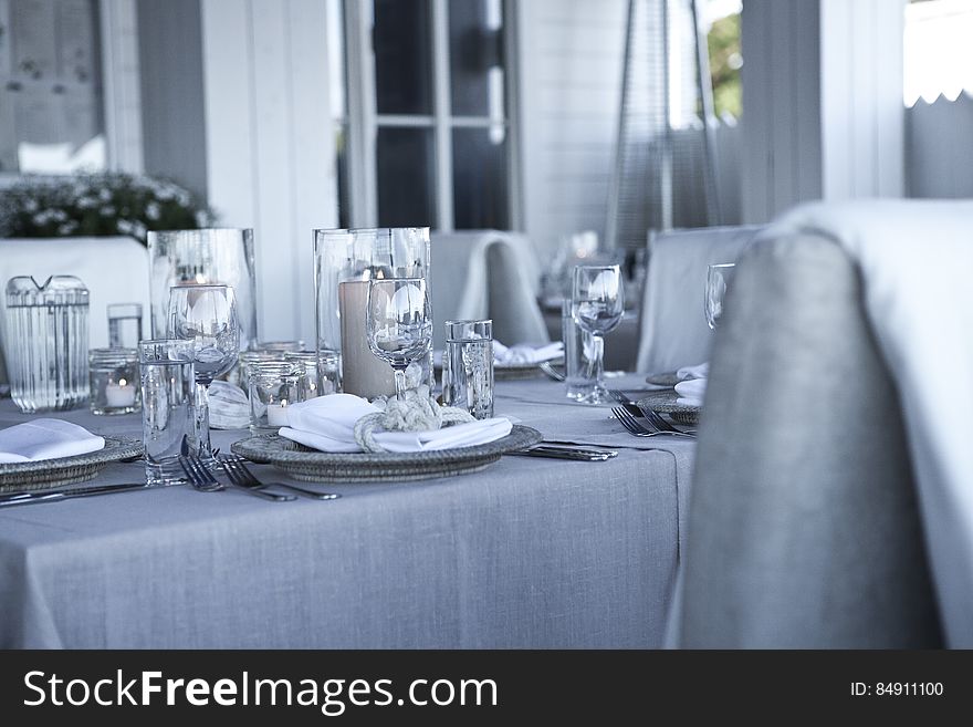 A table set for festive dinner with gray and blue tone. A table set for festive dinner with gray and blue tone.