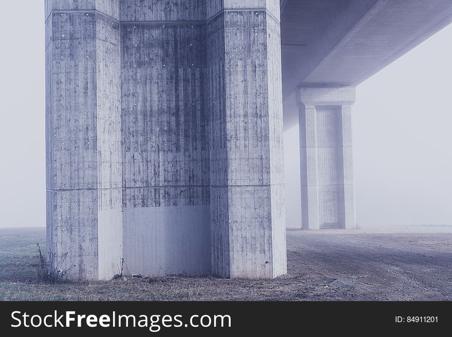 A concrete pylon holding a bridge or raised road.