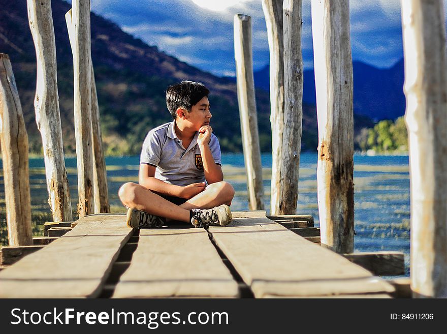 Boy on wooden pier