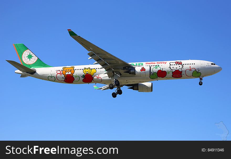 Hello Kitty characters on outside of commercial airliner in flight against blue skies. Hello Kitty characters on outside of commercial airliner in flight against blue skies.