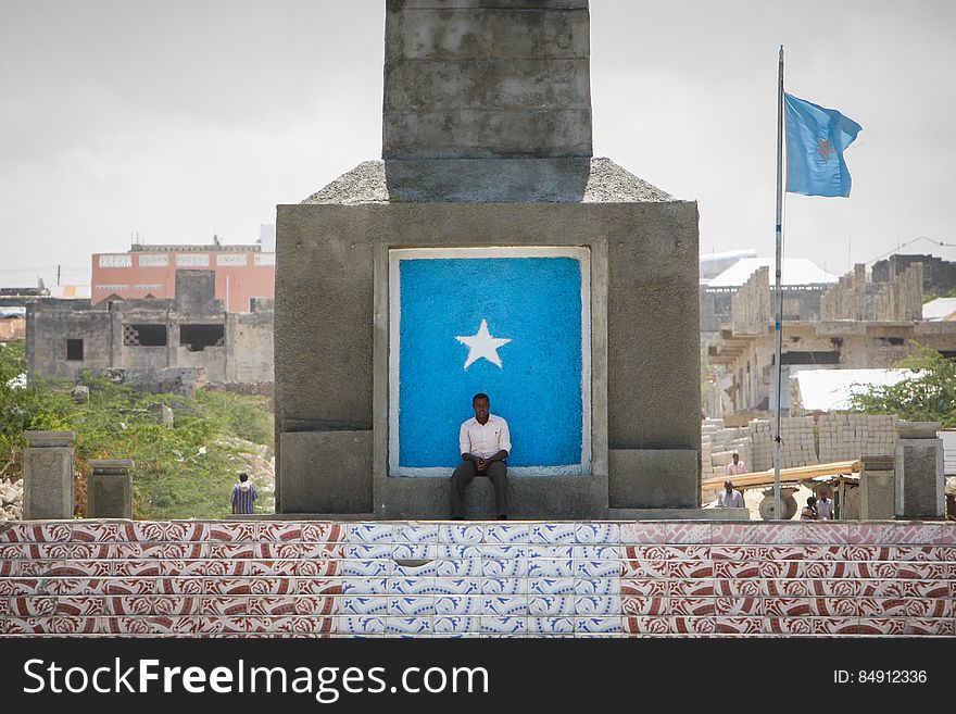 A man sits at the bases of the newly renovated Monument to the Unknown Warrior in the Boondheere district of the Somali capital Mogadishu, 05 August, 2013. 06 August marks 2 years since the Al Qaeda-affiliated extremist group Al Shabaab withdrew from Mogadishu following sustained operations by forces of the Somali National Army &#x28;SNA&#x29; backed by troops of the African Union Mission in Somalia &#x28;AMISOM&#x29; to retake the city. Since the group&#x27;s departure the country&#x27;s captial has re-established itself and a sense of normality has returned. Buildings and infrastructure devastated and destroyed by two decades of conflict have been repaired; thousands of Diaspora Somalis have returned home to invest and help rebuild their nation; foreign embassies and diplomatic missions have reopened and for the first time in many years, Somalia has an internationally recognised government.. AU-UN IST PHOTO / STUART PRICE. A man sits at the bases of the newly renovated Monument to the Unknown Warrior in the Boondheere district of the Somali capital Mogadishu, 05 August, 2013. 06 August marks 2 years since the Al Qaeda-affiliated extremist group Al Shabaab withdrew from Mogadishu following sustained operations by forces of the Somali National Army &#x28;SNA&#x29; backed by troops of the African Union Mission in Somalia &#x28;AMISOM&#x29; to retake the city. Since the group&#x27;s departure the country&#x27;s captial has re-established itself and a sense of normality has returned. Buildings and infrastructure devastated and destroyed by two decades of conflict have been repaired; thousands of Diaspora Somalis have returned home to invest and help rebuild their nation; foreign embassies and diplomatic missions have reopened and for the first time in many years, Somalia has an internationally recognised government.. AU-UN IST PHOTO / STUART PRICE.