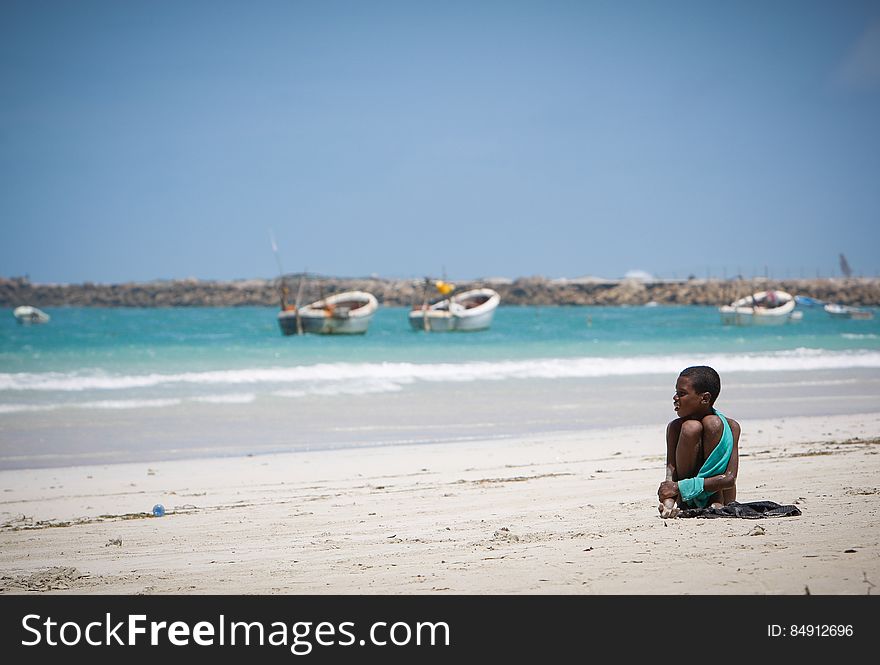 A young boy looks out over boats anchored off Lido Beach in the Kaaraan district of the Somali capital Mogadishu, 05 August, 2013. 06 August marks 2 years since the Al Qaeda-affiliated extremist group Al Shabaab withdrew from Mogadishu following sustained operations by forces of the Somali National Army &#x28;SNA&#x29; backed by troops of the African Union Mission in Somalia &#x28;AMISOM&#x29; to retake the city. Since the group&#x27;s departure the country&#x27;s captial has re-established itself and a sense of normality has returned. Buildings and infrastructure devastated and destroyed by two decades of conflict have been repaired; thousands of Diaspora Somalis have returned home to invest and help rebuild their nation; foreign embassies and diplomatic missions have reopened and for the first time in many years, Somalia has an internationally recognised government.. AU-UN IST PHOTO / STUART PRICE. A young boy looks out over boats anchored off Lido Beach in the Kaaraan district of the Somali capital Mogadishu, 05 August, 2013. 06 August marks 2 years since the Al Qaeda-affiliated extremist group Al Shabaab withdrew from Mogadishu following sustained operations by forces of the Somali National Army &#x28;SNA&#x29; backed by troops of the African Union Mission in Somalia &#x28;AMISOM&#x29; to retake the city. Since the group&#x27;s departure the country&#x27;s captial has re-established itself and a sense of normality has returned. Buildings and infrastructure devastated and destroyed by two decades of conflict have been repaired; thousands of Diaspora Somalis have returned home to invest and help rebuild their nation; foreign embassies and diplomatic missions have reopened and for the first time in many years, Somalia has an internationally recognised government.. AU-UN IST PHOTO / STUART PRICE.