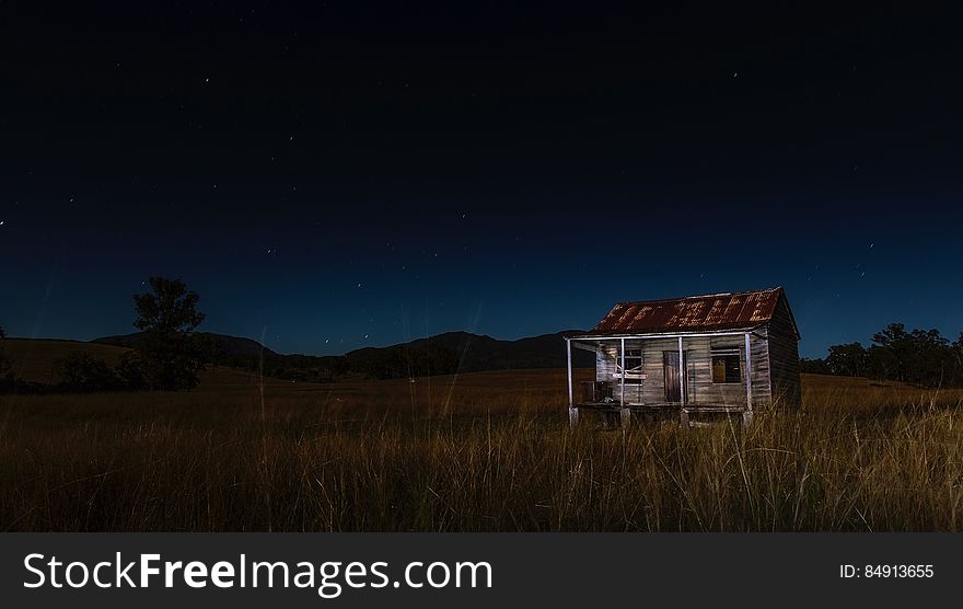 Abandoned barn in countryside at night