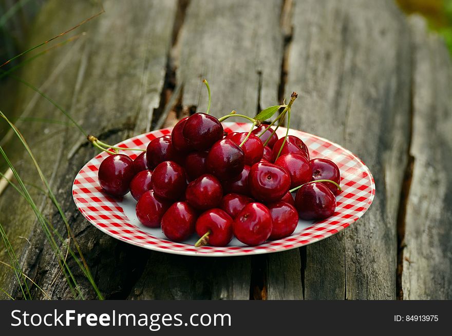 Cherry Fruits on White and Red Ceramic Round Plate