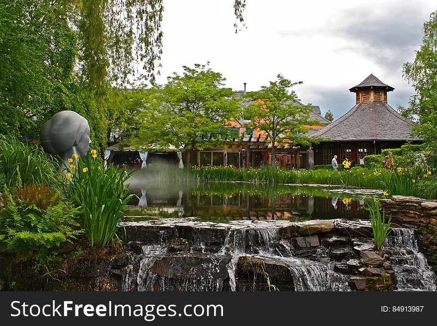 Zen garden including buildings, sculptures and waterfalls.