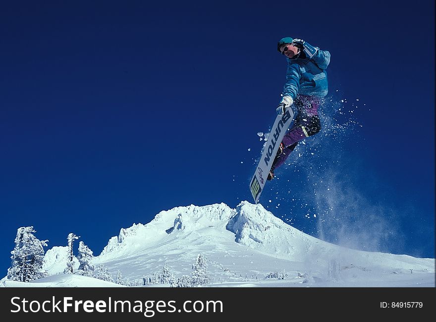 Man Snowboarding during Daytime