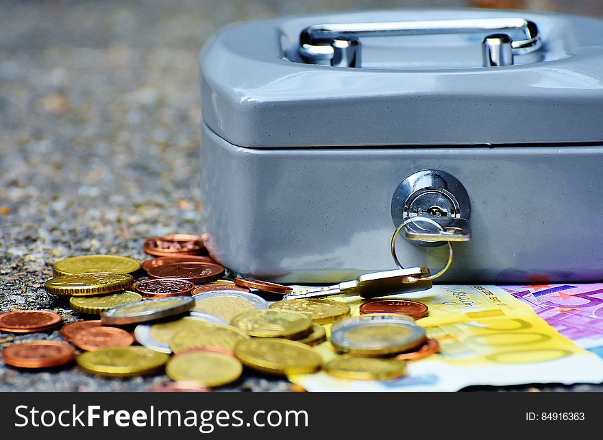 Coins And Bill Beside Coin Case