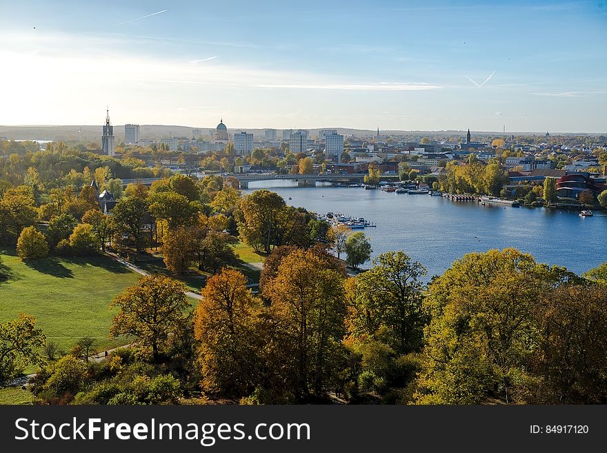 A green park and blue river passing through a city. A green park and blue river passing through a city.