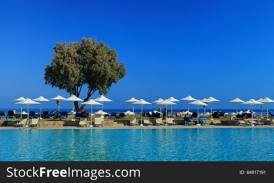 A sunny beach with umbrellas and sun chairs. A sunny beach with umbrellas and sun chairs.