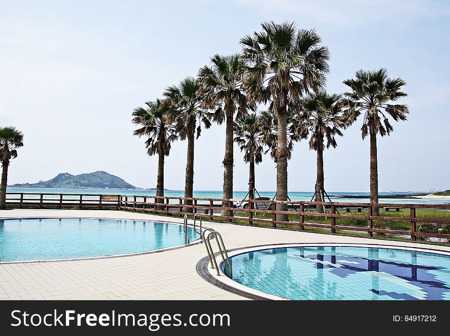 A view of a tropical resort with swimming pools.