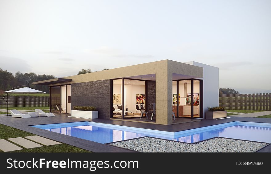 Exterior of modern designers home with swimming pool in countryside. Exterior of modern designers home with swimming pool in countryside.
