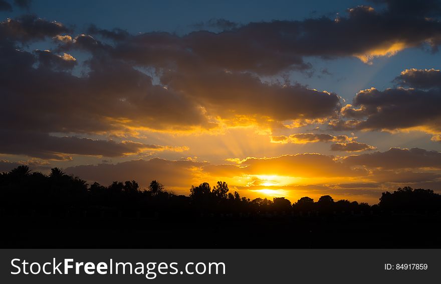 Scenic view of golden sunset in the countryside with cloudscape background. Scenic view of golden sunset in the countryside with cloudscape background.