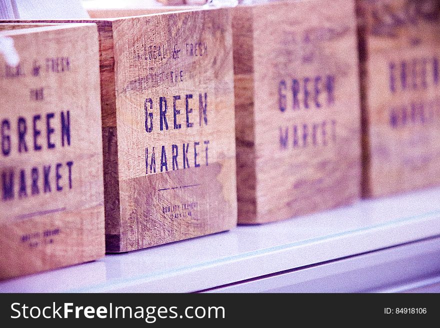 Row of vintage wooden boxes with the words green market.