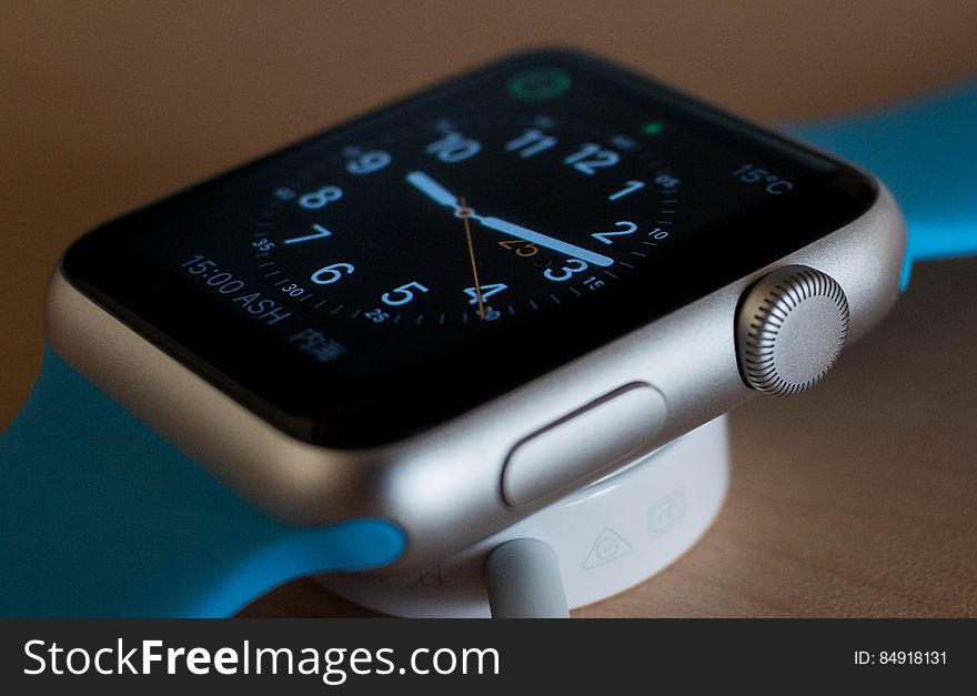 A close up of an Apple watch in its charging dock. A close up of an Apple watch in its charging dock.