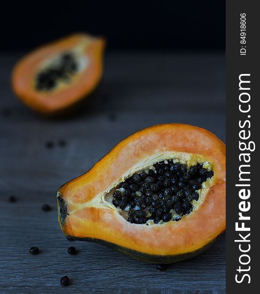 A close up of a halved papaya fruit.