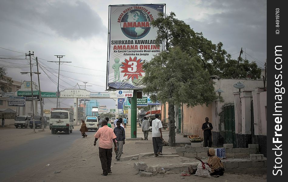 Billboards displaying advertisements for international money transfer companies, are seen new the Kilometre 4 junction in the Somali capital Mogadishu. Millions of people in the Horn of Africa nation Somalia rely on money sent from their relatives and friends abroad in the form of remittances in order to survive, but it is feared that a decision by Barclays Bank to close the accounts of some of the biggest Somali money transfer firms â€“ due to be announced this week - will have a devastating effect on the country and its people. According to the United Nations Development Programme &#x28;UNDP&#x29;, an estimated $1.6 billion US dollars is sent back annually by Somalis living in Europe and North America. Some money transfer companies in Somalia have been accused of being used by pirates to launder money received form ransoms as well as used by Al Qaeda-affiliated extremist group al Shabaab group to fund their terrorist activities and operations in Somalia and the wider East African region. AU/UN IST PHOTO / STUART PRICE. Billboards displaying advertisements for international money transfer companies, are seen new the Kilometre 4 junction in the Somali capital Mogadishu. Millions of people in the Horn of Africa nation Somalia rely on money sent from their relatives and friends abroad in the form of remittances in order to survive, but it is feared that a decision by Barclays Bank to close the accounts of some of the biggest Somali money transfer firms â€“ due to be announced this week - will have a devastating effect on the country and its people. According to the United Nations Development Programme &#x28;UNDP&#x29;, an estimated $1.6 billion US dollars is sent back annually by Somalis living in Europe and North America. Some money transfer companies in Somalia have been accused of being used by pirates to launder money received form ransoms as well as used by Al Qaeda-affiliated extremist group al Shabaab group to fund their terrorist activities and operations in Somalia and the wider East African region. AU/UN IST PHOTO / STUART PRICE.