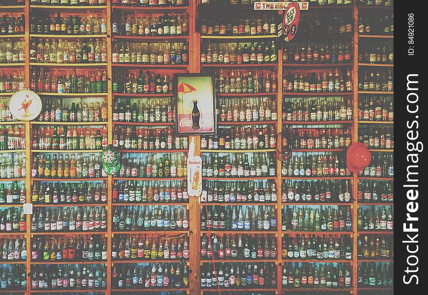 Collection Of Glass Soda And Beer Bottles On Shelves