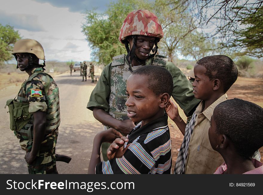 A Burundian soldier serving with the African Union Mission in Somalia &#x28;AMISOM&#x29; greets children in the village of Modmoday approx. 40km east of the central Somali town of Baidoa. The Burundians, together with forces of the Somali National Army &#x28;SNA&#x29; have been mounting &#x27;snap&#x27; foot patrols in villages and areas to the east of Baidoa where Al Qaeda-affiliated extremist group Al Shabaab mount attacks against local herdsmen, villages and travelers along the busy Baidoa-Mogadishu road. The AMISOM troops also use the patrols as an opportunity to provide occasional free medical treatment and fresh, potable drinking water for residents in the area. AU/UN IST PHOTO / ABDI DAKAN. A Burundian soldier serving with the African Union Mission in Somalia &#x28;AMISOM&#x29; greets children in the village of Modmoday approx. 40km east of the central Somali town of Baidoa. The Burundians, together with forces of the Somali National Army &#x28;SNA&#x29; have been mounting &#x27;snap&#x27; foot patrols in villages and areas to the east of Baidoa where Al Qaeda-affiliated extremist group Al Shabaab mount attacks against local herdsmen, villages and travelers along the busy Baidoa-Mogadishu road. The AMISOM troops also use the patrols as an opportunity to provide occasional free medical treatment and fresh, potable drinking water for residents in the area. AU/UN IST PHOTO / ABDI DAKAN.