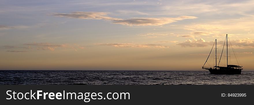 Panorama of sailboat on waters at sunset. Panorama of sailboat on waters at sunset.