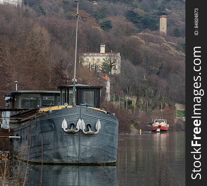 Metal hulled ship moored to waterfront. Metal hulled ship moored to waterfront.