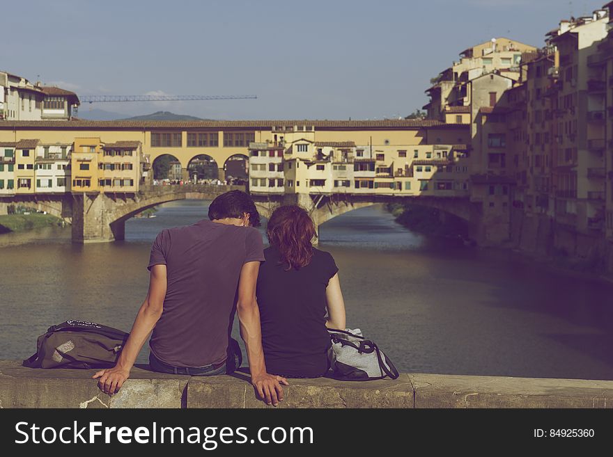 Couple Sitting Together Near Ponte Vecchio