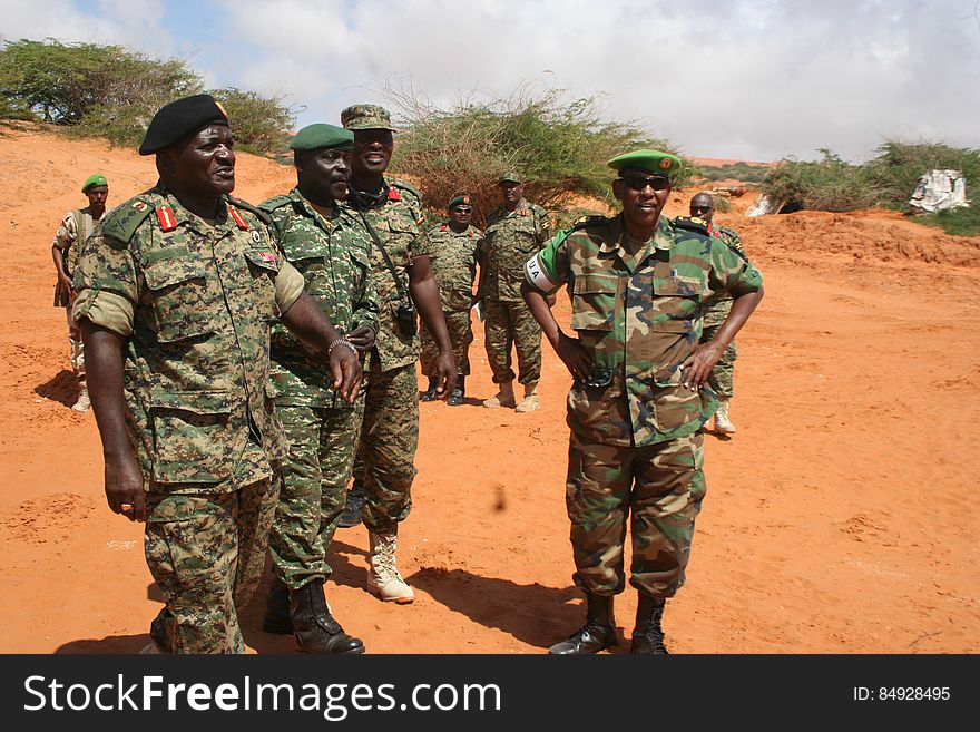 African soldiers in uniform standing in field on sunny day. African soldiers in uniform standing in field on sunny day.