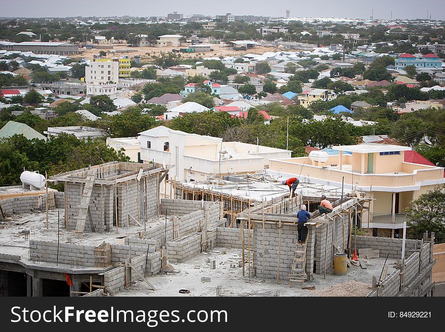 Construction workers work on a building in the Medina district of the Somali capital Mogadishu, 05 August, 2013. 06 August marks 2 years since the Al Qaeda-affiliated extremist group Al Shabaab withdrew from Mogadishu following sustained operations by forces of the Somali National Army &#x28;SNA&#x29; backed by troops of the African Union Mission in Somalia &#x28;AMISOM&#x29; to retake the city. Since the group&#x27;s departure the country&#x27;s captial has re-established itself and a sense of normality has returned. Buildings and infrastructure devastated and destroyed by two decades of conflict have been repaired; thousands of Diaspora Somalis have returned home to invest and help rebuild their nation; foreign embassies and diplomatic missions have reopened and for the first time in many years, Somalia has an internationally recognised government.. AU-UN IST PHOTO / STUART PRICE. Construction workers work on a building in the Medina district of the Somali capital Mogadishu, 05 August, 2013. 06 August marks 2 years since the Al Qaeda-affiliated extremist group Al Shabaab withdrew from Mogadishu following sustained operations by forces of the Somali National Army &#x28;SNA&#x29; backed by troops of the African Union Mission in Somalia &#x28;AMISOM&#x29; to retake the city. Since the group&#x27;s departure the country&#x27;s captial has re-established itself and a sense of normality has returned. Buildings and infrastructure devastated and destroyed by two decades of conflict have been repaired; thousands of Diaspora Somalis have returned home to invest and help rebuild their nation; foreign embassies and diplomatic missions have reopened and for the first time in many years, Somalia has an internationally recognised government.. AU-UN IST PHOTO / STUART PRICE.