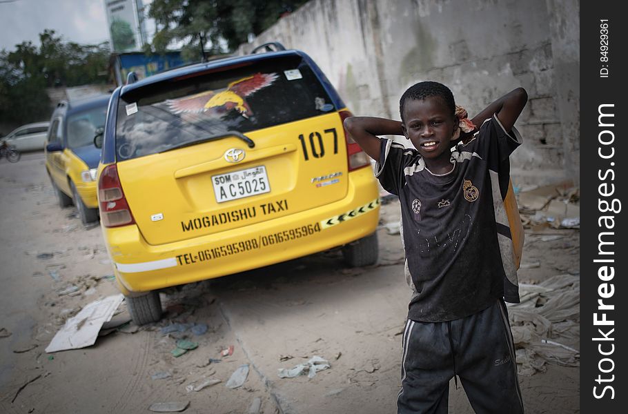 A young boy stands next to cars of the Mogadishu Taxi Company next to the company&#x27;s head office in the Somali capital Mogadishu, 01 September 2013. Operating since the end of May of this year in the city&#x27;s dusty and once again bustling streets and thoroughfares, the MTC&#x27;s distinctive yellow and purple cars offer customers taxi fares around Mogadishu at competitive rates and in the first 3 months of operations, the company has increased it&#x27;s fleet of vehicles from an initial 25 to over 100. The company, according to one of it&#x27;s drivers, also enables employment opportunities for Somalia&#x27;s youth following two decades of conflict in the Horn of Africa nation that shattered a generation. Now, thanks to the relative peace that has followed the departure of the Al-Qaeda-affiliated extremist group Al Shabaab from the city; an internationally recognised government for the first time in years and thousands of Diaspora Somalis returning home to invest in and rebuild their country, the MTC is one of many new companies establishing itself in the new Mogadishu and offering services that were hitherto impossible to provide. AU-UN IST PHOTO / STUART PRICE. A young boy stands next to cars of the Mogadishu Taxi Company next to the company&#x27;s head office in the Somali capital Mogadishu, 01 September 2013. Operating since the end of May of this year in the city&#x27;s dusty and once again bustling streets and thoroughfares, the MTC&#x27;s distinctive yellow and purple cars offer customers taxi fares around Mogadishu at competitive rates and in the first 3 months of operations, the company has increased it&#x27;s fleet of vehicles from an initial 25 to over 100. The company, according to one of it&#x27;s drivers, also enables employment opportunities for Somalia&#x27;s youth following two decades of conflict in the Horn of Africa nation that shattered a generation. Now, thanks to the relative peace that has followed the departure of the Al-Qaeda-affiliated extremist group Al Shabaab from the city; an internationally recognised government for the first time in years and thousands of Diaspora Somalis returning home to invest in and rebuild their country, the MTC is one of many new companies establishing itself in the new Mogadishu and offering services that were hitherto impossible to provide. AU-UN IST PHOTO / STUART PRICE.