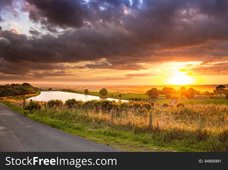 Scenic View of Agricultural Field Against Dramatic Sky