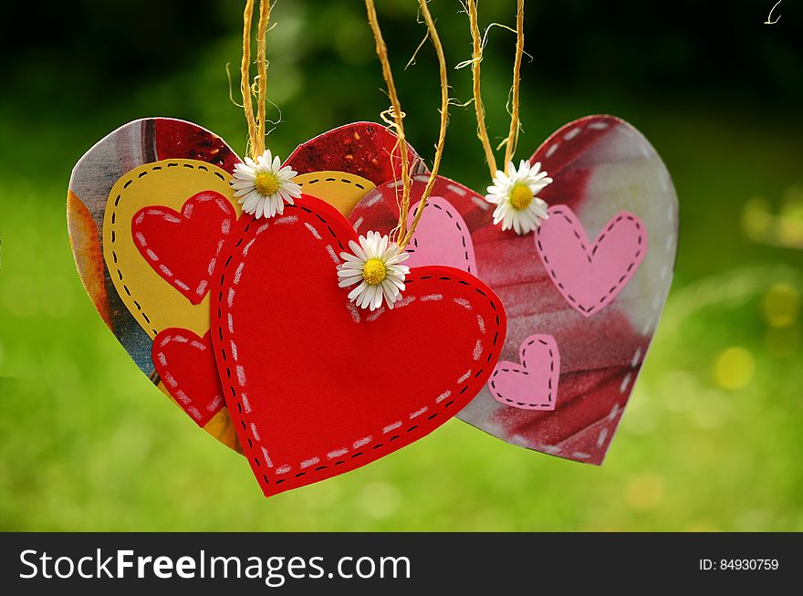 Three Red Hearts Hanging With White Flowers