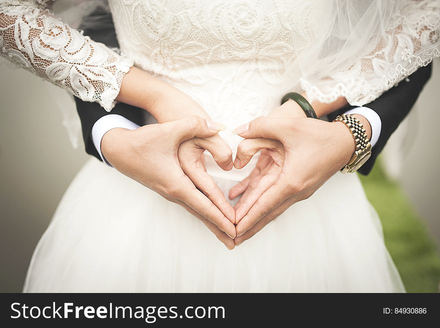 Midsection Of Woman Making Heart Shape With Hands