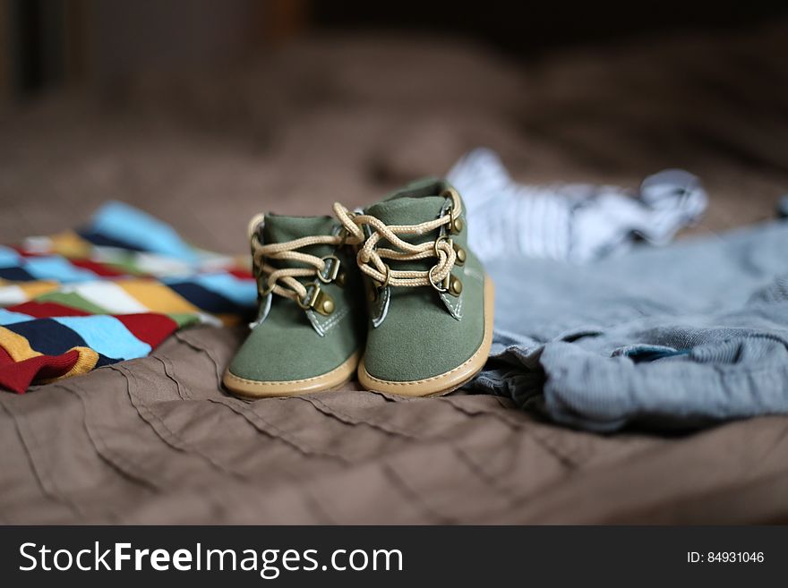 Baby&#x27;s Green and Beige Sneakers on Brown Textile