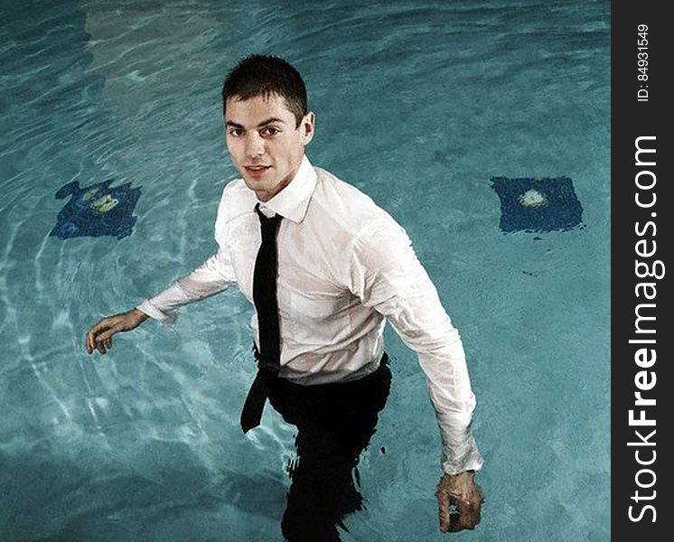 Businessman in a Swimming Pool --- Image by Â© Serge Kozak/zefa/Corbis. Businessman in a Swimming Pool --- Image by Â© Serge Kozak/zefa/Corbis