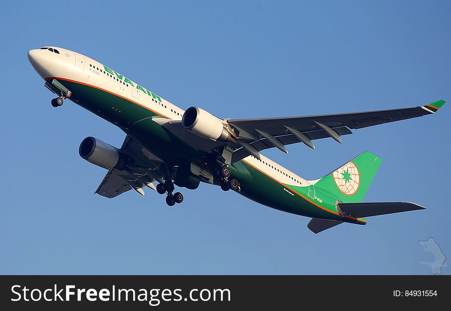 Eva Air airline plane in flight against blue skies. Eva Air airline plane in flight against blue skies.