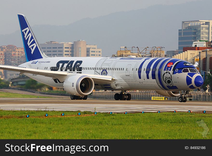 ANA airliner on runway at airport.