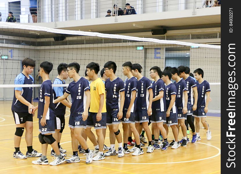 People shake hands after a volleyball game to show good sportsmanship.