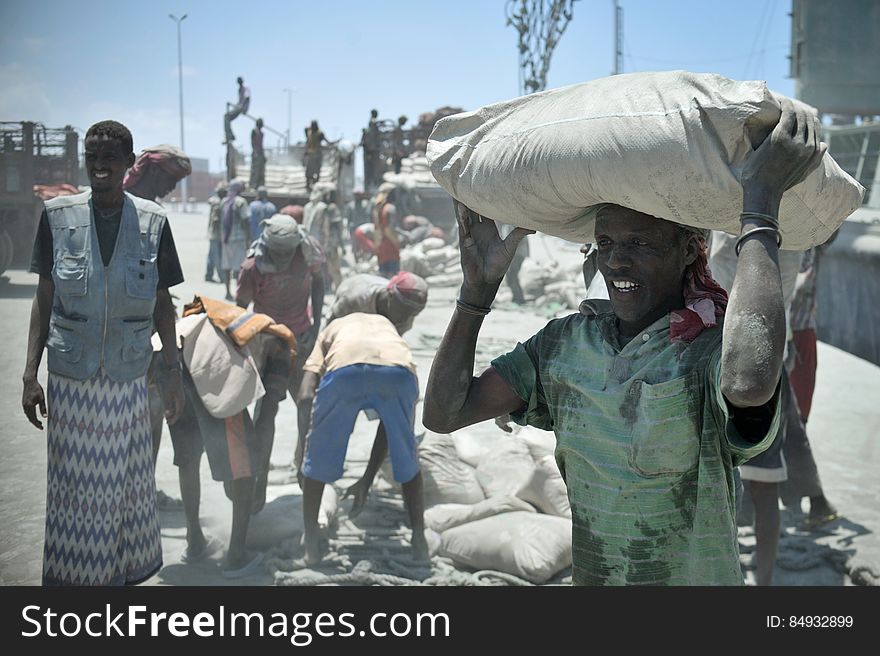 A Somali man in Mogadishu&#x27;s main port carries cement, just offloaded from a ship, into a waiting truck nearby on April 15. Despite the continued threat of al Shabaab in Somalia, much of daily life in Mogadishu has returned to normal, and the capital&#x27;s economy growing fast. AU UN IST / TOBIN JONES. A Somali man in Mogadishu&#x27;s main port carries cement, just offloaded from a ship, into a waiting truck nearby on April 15. Despite the continued threat of al Shabaab in Somalia, much of daily life in Mogadishu has returned to normal, and the capital&#x27;s economy growing fast. AU UN IST / TOBIN JONES.