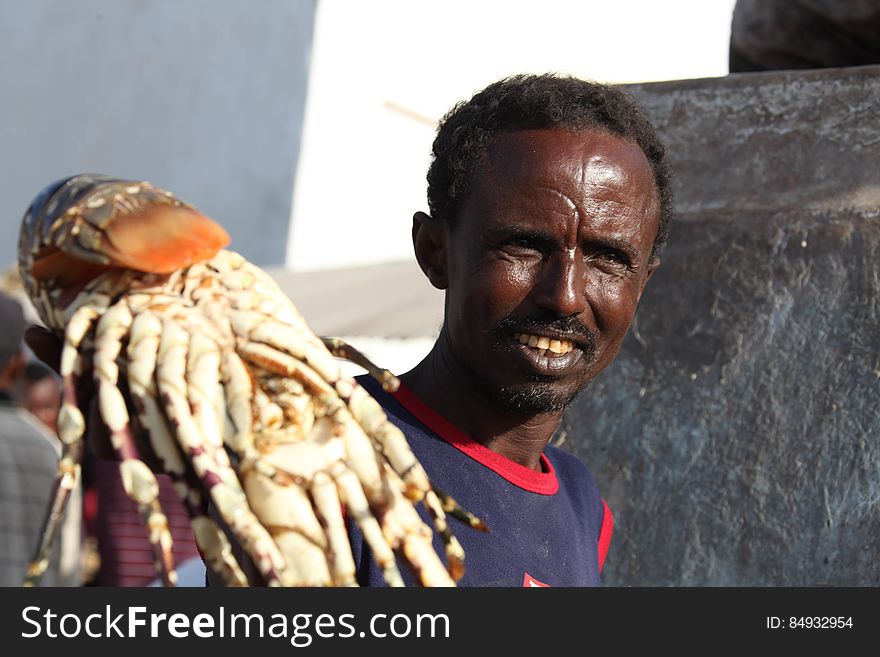 A Somali fisherman holds up a lobster in Hamar Weyn district&#x27;s fish market caught in the Indian ocean off of the coast of Mogadishu, Somalia, on May 22. AU UN IST PHOTO / Ilyas A. Abukar. A Somali fisherman holds up a lobster in Hamar Weyn district&#x27;s fish market caught in the Indian ocean off of the coast of Mogadishu, Somalia, on May 22. AU UN IST PHOTO / Ilyas A. Abukar