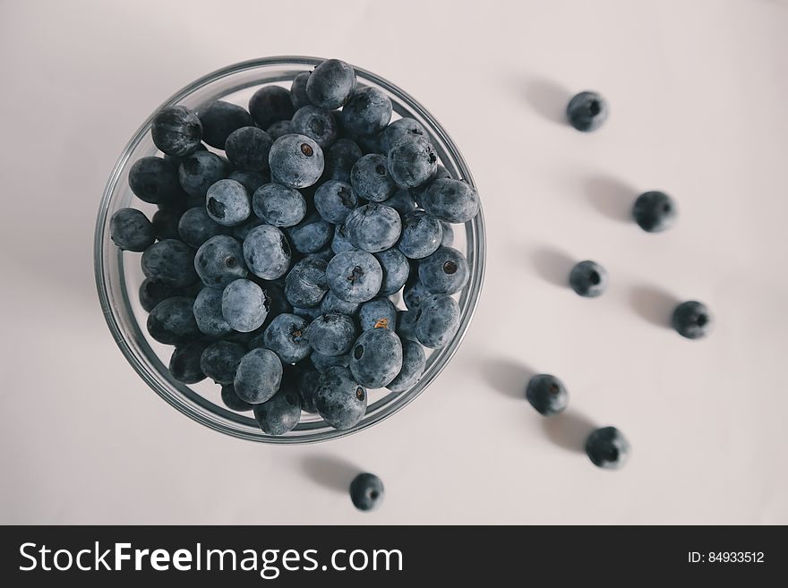 A glass bowl with blueberries. A glass bowl with blueberries.