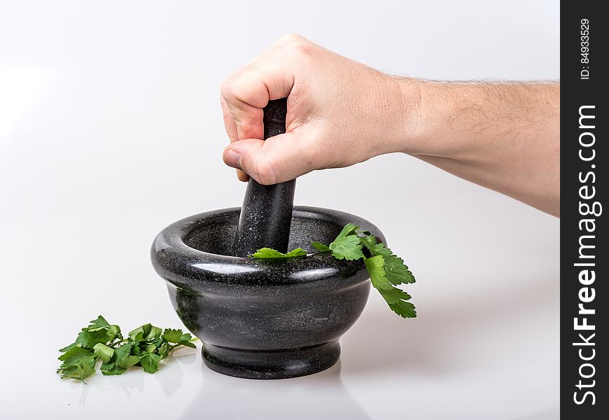 Human Holding Black Ceramic Pestle