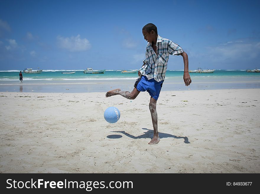 A Somali boy plays football on Lido Beach in the Kaaraan district of the Somali capital Mogadishu, 05 August, 2013. 06 August marks 2 years since the Al Qaeda-affiliated extremist group Al Shabaab withdrew from Mogadishu following sustained operations by forces of the Somali National Army &#x28;SNA&#x29; backed by troops of the African Union Mission in Somalia &#x28;AMISOM&#x29; to retake the city. Since the group&#x27;s departure the country&#x27;s captial has re-established itself and a sense of normality has returned. Buildings and infrastructure devastated and destroyed by two decades of conflict have been repaired; thousands of Diaspora Somalis have returned home to invest and help rebuild their nation; foreign embassies and diplomatic missions have reopened and for the first time in many years, Somalia has an internationally recognised government.. AU-UN IST PHOTO / STUART PRICE. A Somali boy plays football on Lido Beach in the Kaaraan district of the Somali capital Mogadishu, 05 August, 2013. 06 August marks 2 years since the Al Qaeda-affiliated extremist group Al Shabaab withdrew from Mogadishu following sustained operations by forces of the Somali National Army &#x28;SNA&#x29; backed by troops of the African Union Mission in Somalia &#x28;AMISOM&#x29; to retake the city. Since the group&#x27;s departure the country&#x27;s captial has re-established itself and a sense of normality has returned. Buildings and infrastructure devastated and destroyed by two decades of conflict have been repaired; thousands of Diaspora Somalis have returned home to invest and help rebuild their nation; foreign embassies and diplomatic missions have reopened and for the first time in many years, Somalia has an internationally recognised government.. AU-UN IST PHOTO / STUART PRICE.