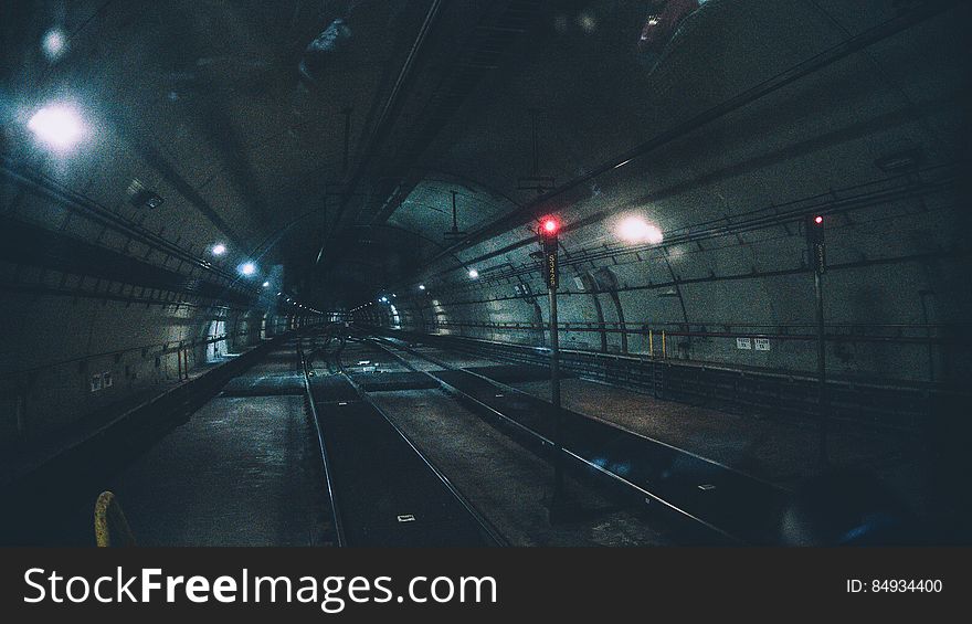 Underground railway tube tunnel receding into distance.