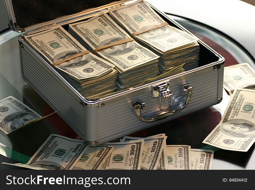 Hundred dollar bills in a metal case. Hundred dollar bills in a metal case.