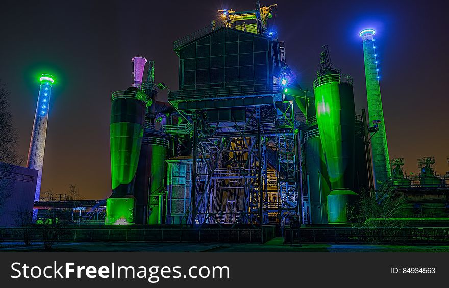 An industrial lot at night with colorful lights. An industrial lot at night with colorful lights.