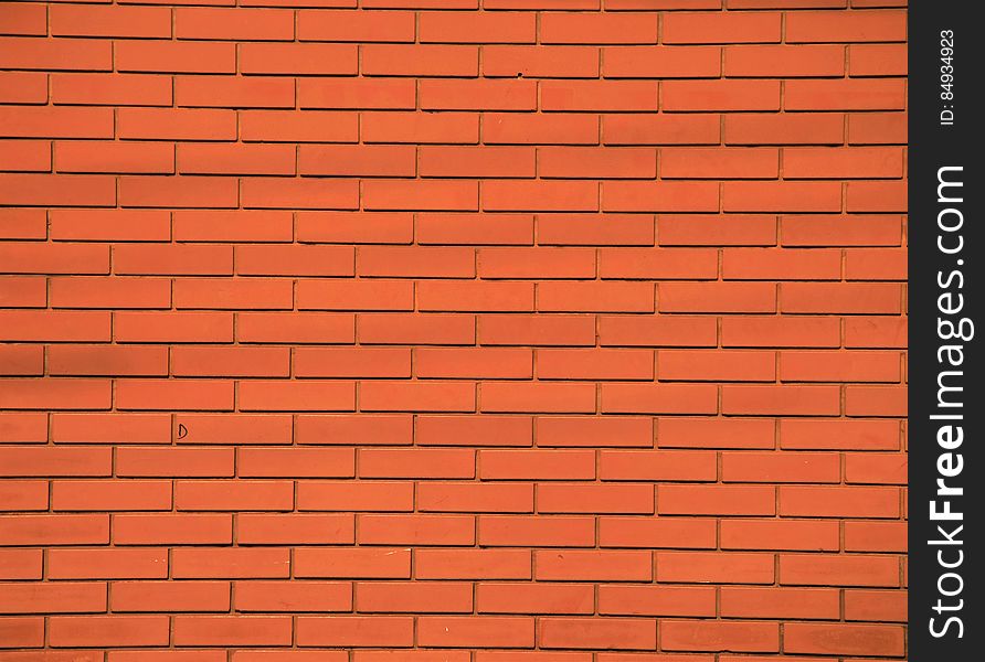 Bright orange brick building wall. Bright orange brick building wall.